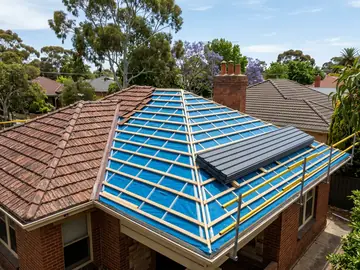 Roof part-way through replacement, with new battens, sarking and steel sheets